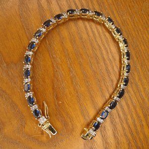 Gold tone bracelet with blue sapphires and white rhinestones.